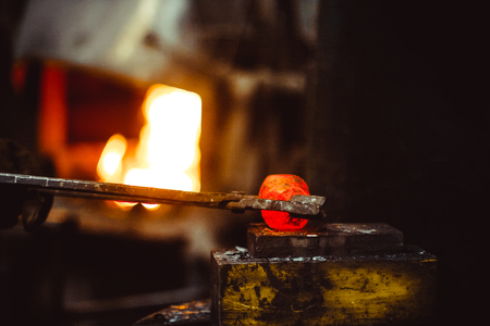 blacksmith working in the forge on auto hammerの写真素材