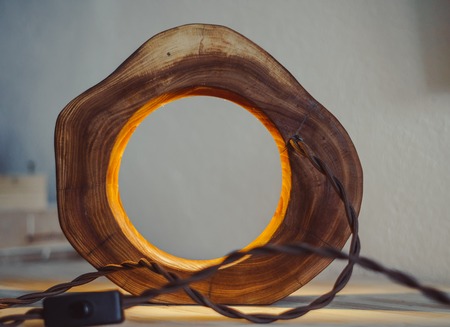 wood lamp handmade in front of a white wallの写真素材