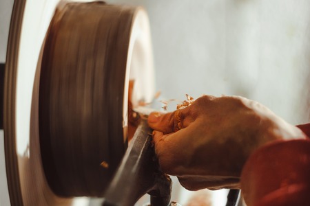 Foot operated spring pole wood lathe.Man operating a foot operated spring pole wood lathe.の写真素材