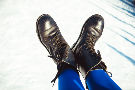 Legs of a woman in shoes at a winter resortの写真素材