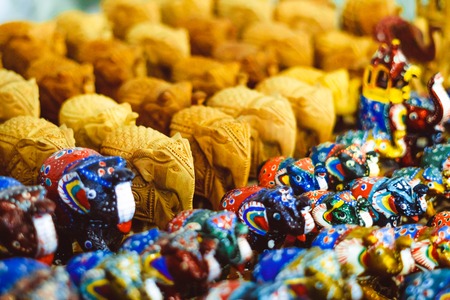 The carved wooden or stone elephants are famous souvenirs, that often are covered with different patterns and serve as the symbols of luck and nice memories of vacationの写真素材