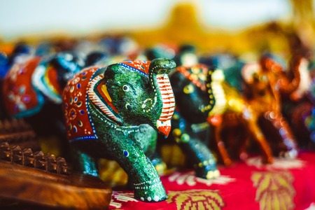 The carved wooden or stone elephants are famous souvenirs, that often are covered with different patterns and serve as the symbols of luck and nice memories of vacationの写真素材