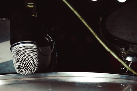 microphone for drum set-up on wall backgroundの写真素材
