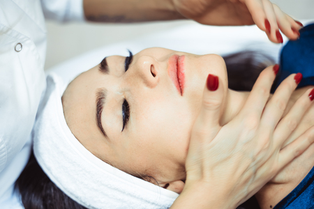 Young, beautiful and healthy woman in spa salon. Traditional oriental massage therapy and beauty treatments.の写真素材