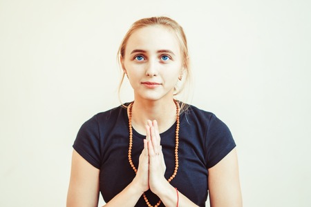 the girl yoga teacher put their palms togetherの写真素材