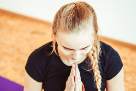 the girl yoga teacher put their palms togetherの写真素材