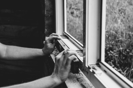 worker checks the level of a windowの写真素材