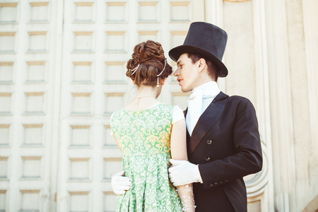 Beautiful gorgeous couple in elegant evening dresses in a classic interior. Fashion, glamour.の写真素材