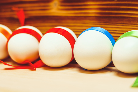 Colorful Easter eggs close-up tied with ribbonsの写真素材