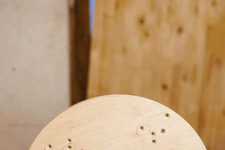 the worker turns the wood on a lathe in his workshopの写真素材
