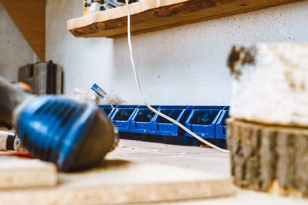 Electric hammer drill lies on a wooden tableの写真素材