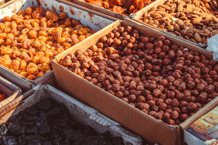 Dry fruits and spices like cashews, raisins, cloves, anise, etc. on display for sale in a bazaar in bangalore, india.の写真素材