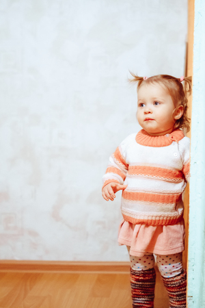 a little girl in a blouse with tails is at homeの写真素材