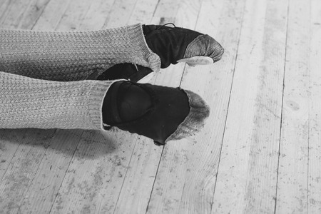 legs of the ballerina during the warm-up in the ballet hall