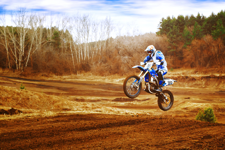 A picture of a biker making a stunt and jumps in the airの写真素材