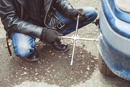 Change a flat car tire on road with Tire maintenance, damaged car tyre