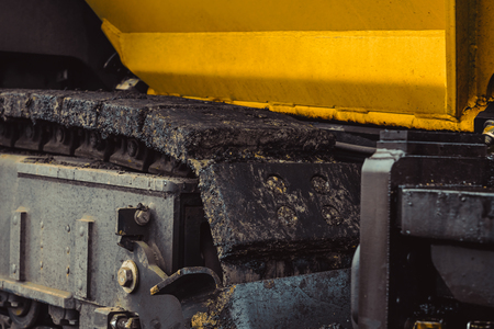 Road construction works with roller compactor machine and asphalt finisherの写真素材