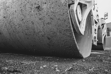 Road construction works with roller compactor machine and asphalt finisherの写真素材