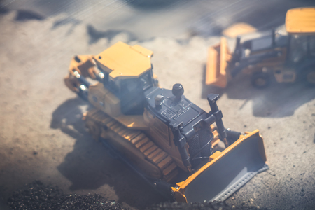 toy yellow tractor in the scenery of coal miningの写真素材