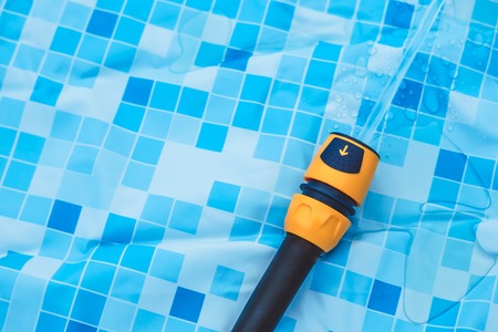Close-up of garden hose water with in rubber poolの写真素材