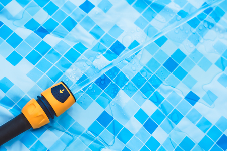 Close-up of garden hose water with in rubber pool
