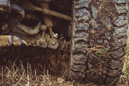 off-road wheel in the mud standing on the grass before the startの写真素材