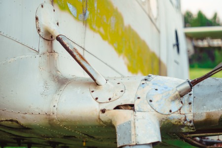 the old plane stands on the field with broken wingsの写真素材
