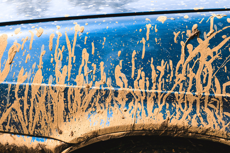 Fragment of dirty car in rural areas close-upの写真素材