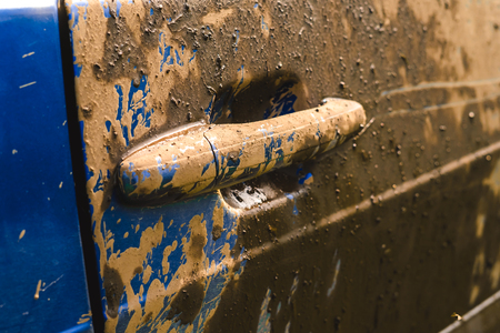 Fragment of dirty car in rural areas close-upの写真素材