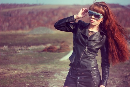 beautiful girl in leather jacket on the fieldの写真素材