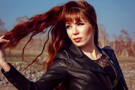 beautiful girl in leather jacket on the field