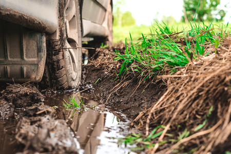 the wheel of a passenger car stuck in the mud on an off-roadの写真素材
