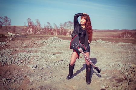 beautiful girl in leather jacket with guitarの写真素材