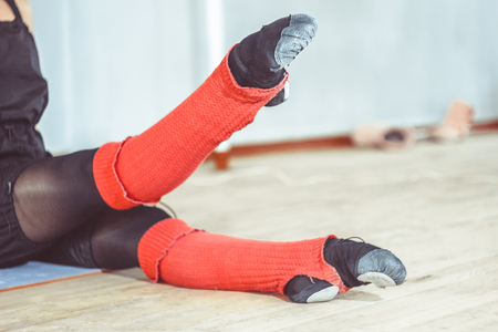 legs of the ballerina during the warm-up in the ballet hallの写真素材