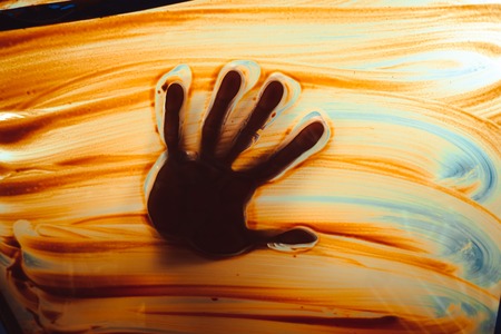 Handprint on dirty glass window abstract backgroundの写真素材