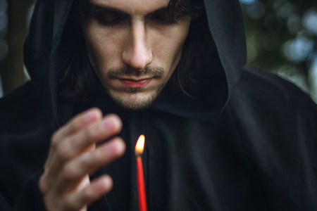 the monk in the dark over the candle idly byの写真素材