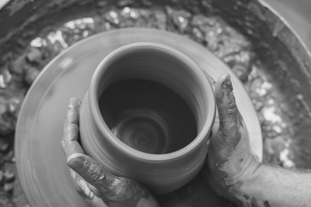 Potter at work. makes a jug out of clayの写真素材