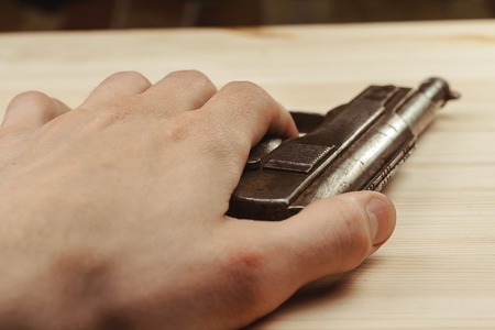 Killer with gun close up over grunge background with copyspace.の写真素材