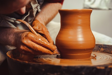 Potter at work. makes a jug out of clayの写真素材