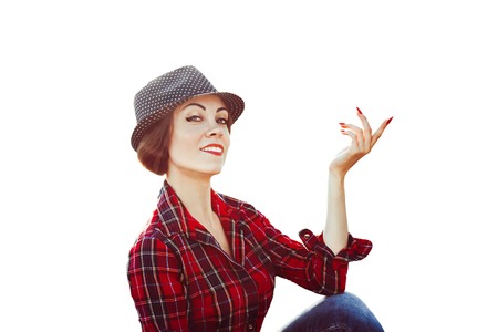 Portrait of an elegant beautiful woman in shirt and wide hat on white background in studio