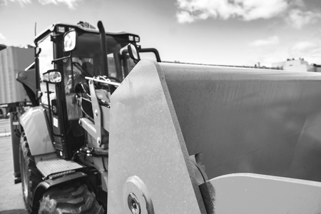 The hydraulic tractor is yellow. Crawler bulldozer at the exhibition