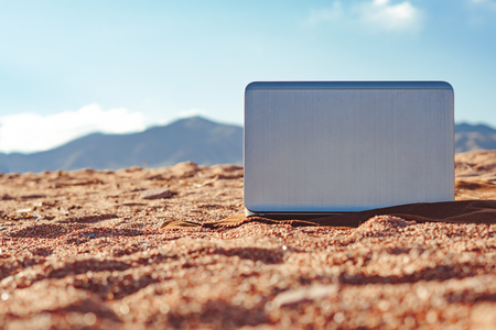 laptop on the sand on a blanket by the seaの写真素材