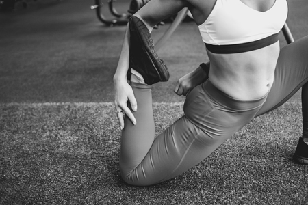 woman doing leg stretching, in a butterfly poseの写真素材