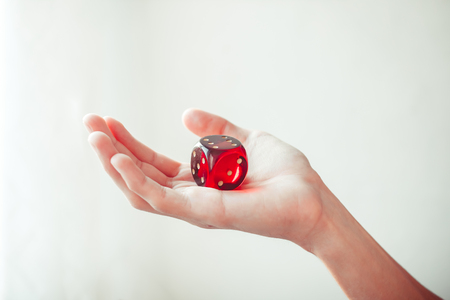 Hand throwing red dices, good luck concept.の写真素材