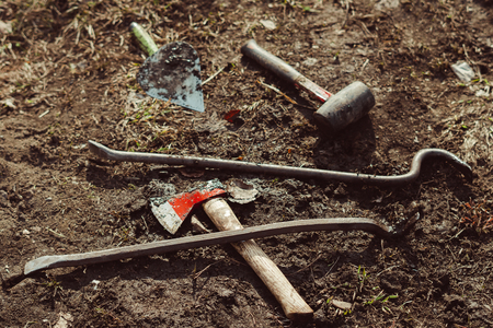 garden tools axe and crowbar lie on the ground