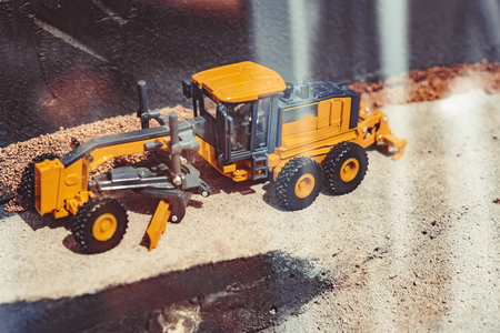 toy yellow tractor in the scenery of coal miningの写真素材