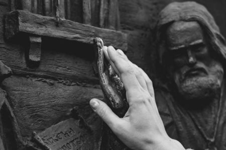 bronze hand of the monument is polished to a Shine for good luck rubbing the palm of your handの写真素材