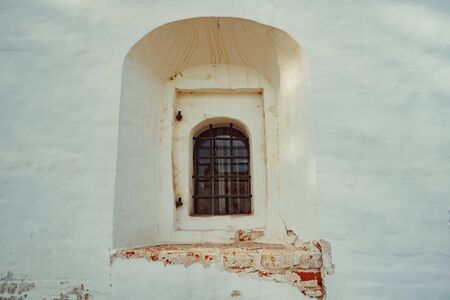 a window in an old building with a lattice set deep in the wall, the old Churchの写真素材