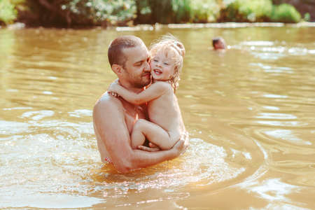 the father with the child in the waterの写真素材