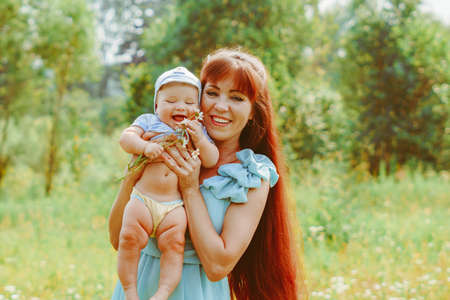 mother raises the child in her armsの写真素材